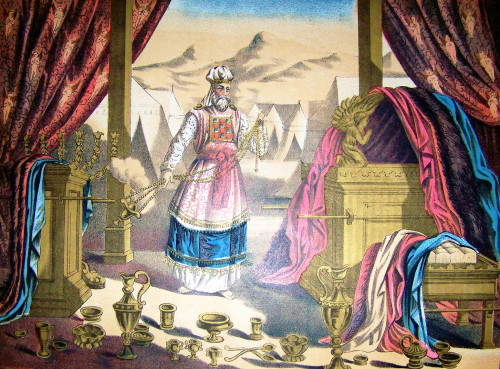 Here the High Priest is pictured in his priestly garments, surrounded by the furniture of the Tabernacle. [Image: Holman Bible / Wiki Commons]